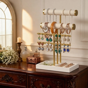 Multilevel gold jewelry stand with white velvet bars for necklaces and earrings display