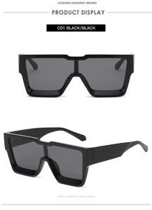 Detail view of oversized square sunglasses in C01 black with thick frames and dark lenses