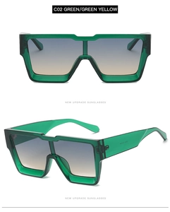 Detail of green oversized square sunglasses with blue-yellow gradient lenses and transparency