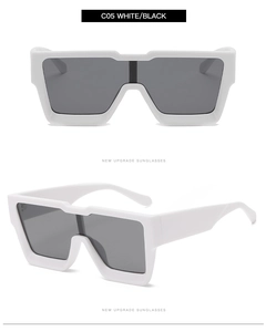 Detail view of bold white oversized square sunglasses frame with dark grey lenses