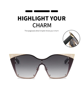 Detailed view of cat eye sunglasses with gradient lenses and gold metal cutout trim