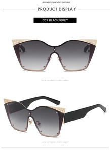 Detail view of cat eye sunglasses featuring gold cut-out metal accents on the frame top