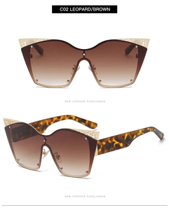 Detail of leopard print arms and gold hollow patterns on oversized cat eye sunglasses
