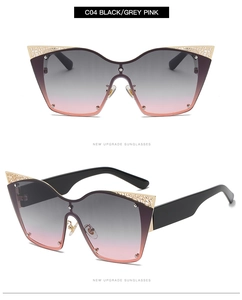 Detail of cat eye sunglasses with gold hollow metal trim and grey pink gradient lenses