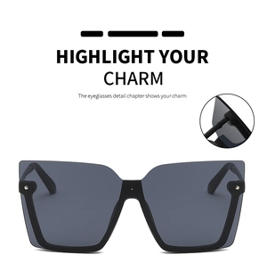 Detail view of square half-frame sunglasses featuring silver rivets and wide black temples