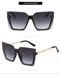 Detail view of square gradient grey sunglasses with gold metal temples and black frame