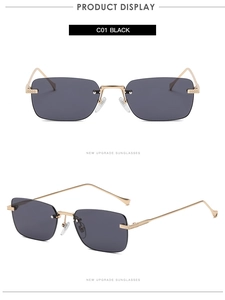 Detail view of rimless rectangular sunglasses with gold metal frame and black lenses
