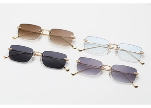 Flat lay of four rimless square sunglasses in gold metal with gradient colored lenses