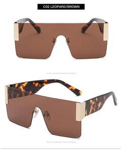 Detail of oversized leopard print square sunglasses with brown lens and gold hinge