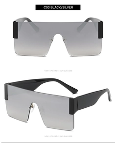 Detail view of large square frame sunglasses with silver gradient lenses and black temples