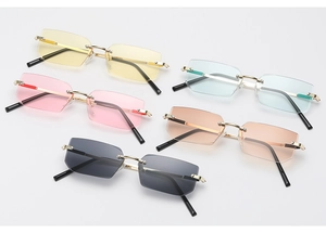 Detailed arrangement of five multi-colored rimless rectangular sunglasses with gold temples