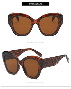 Detail of leopard print cat eye sunglasses with wide V-shaped temples and brown lenses