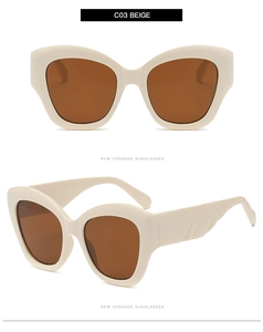 Detail view of beige cat eye sunglasses featuring wide textured temples and dark lenses