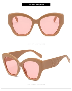 Detail of cat eye sunglasses with brown frame, pink lenses and textured temples