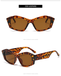 Dettaglio occhiali da sole cat-eye con montatura leopardata e lenti marroni colorate