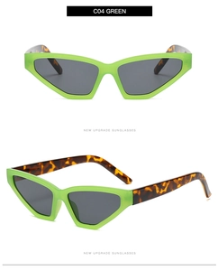 Detail view of neon green cat eye sunglasses with tortoise temples and dark gray lenses