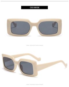Detail view of stylish beige rectangular sunglasses with thick frames and grey lenses