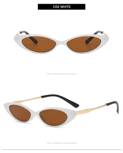 Detail view of white cat-eye sunglasses featuring brown lenses and metal frame structure