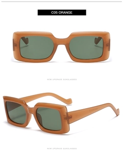 Detail of trendy orange square sunglasses with green lenses and thick temples