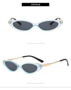 Close-up of narrow retro sunglasses with transparent blue frame and golden metal temples