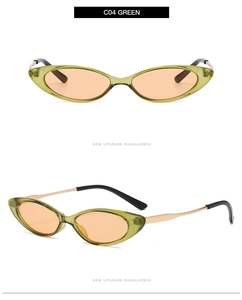 Detail view of cat eye sunglasses with green resin frames and golden metal temples