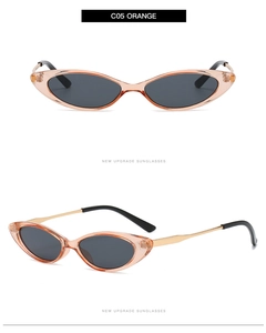 Detail view of small cat eye sunglasses with orange frames and gold metal temples