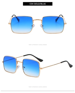Détail de lunettes de soleil carrées dorées avec verres dégradés bleus et monture fine