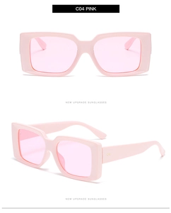 Detail view of pink rectangular sunglasses with thick frames and light pink lenses