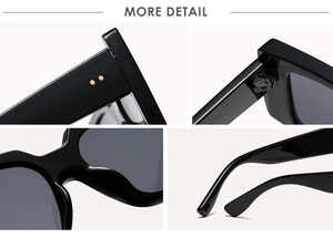 Detail view of black square sunglasses featuring golden rivets and reinforced metal hinges