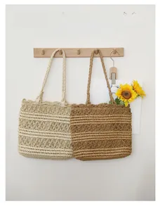 Close-up of beige and brown hollow crochet straw tote bag showing texture and structure