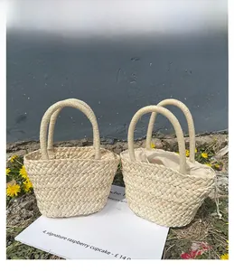 Detail of hand-woven straw basket bag with thick plant fiber texture and drawstring liner