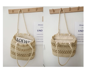 Detail of hollow straw shoulder bag showing fabric lining and secure zipper closure