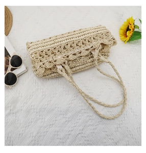 Detailed top view of a cream hollow flower weave straw tote bag with summer accessories