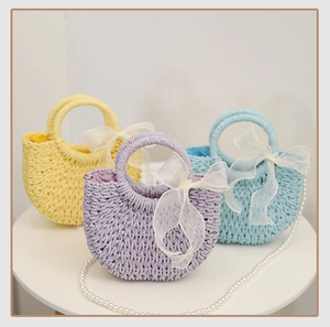 Detailed trio of colorful straw bags with elegant organza bows and pearl chain straps