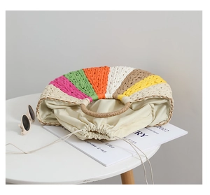 Detail of colorful rainbow woven straw tote bag with round handle and drawstring lining