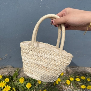 Mini corn husk woven handbag with half-moon shape and rustic beige summer style