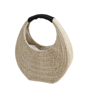Handmade straw woven handbag with black leather handles for summer beach vacation