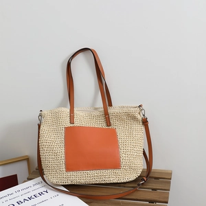 French straw tote bag with orange leather pocket and strap for beach vacations