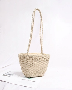 Detail of handmade straw tote bag with beige fabric drawstring lining and woven texture