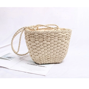 Handmade woven straw tote bag with rope handles for beach vacations and rustic style