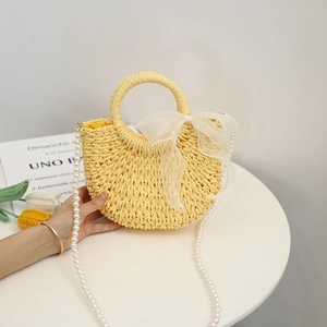 Cute yellow straw woven bag with white organza bow and pearl crossbody strap
