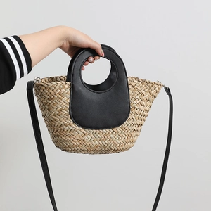 Handmade straw crossbody bag with black leather handles for summer beach vacations