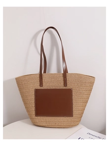 Detail of hand-woven straw tote bag with premium dark brown leather pocket and strap