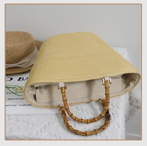 Detail of the woven straw tote with bamboo handles and spacious fabric-lined interior