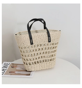 Detailed close-up of retro hollow straw tote with black leather handles and fabric lining