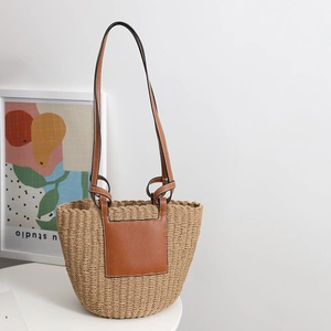 French vintage straw tote bag with brown leather handles for summer beach holidays