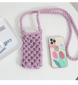 Close-up of purple hand-woven crochet mobile phone bag with mesh cotton cord texture