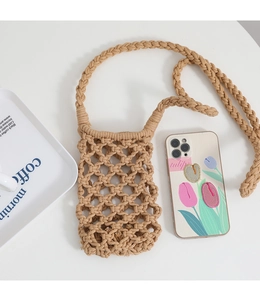 Close-up of the handmade woven hollow grid cotton phone bag with long strap in khaki