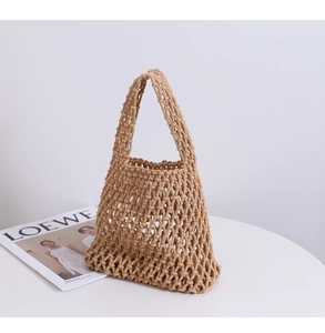 Close-up of handmade woven mesh tote bag with minimalist cotton rope texture and handle