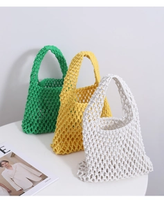 Detailed knit texture of handmade cotton mesh handbags in green, yellow, and white